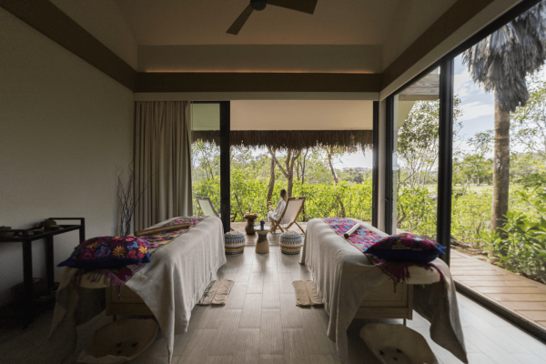 two massage beds in treatment room with corner windows